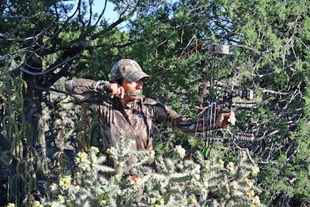 An experienced huntress and guide, Mia Anstine takes aim with her bow.