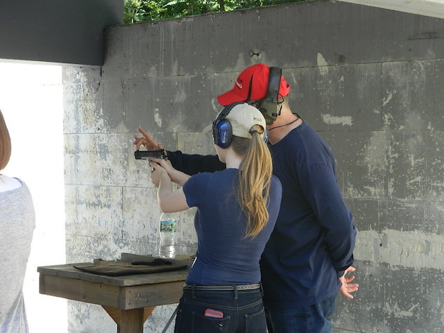 Girl on the range shoot gun