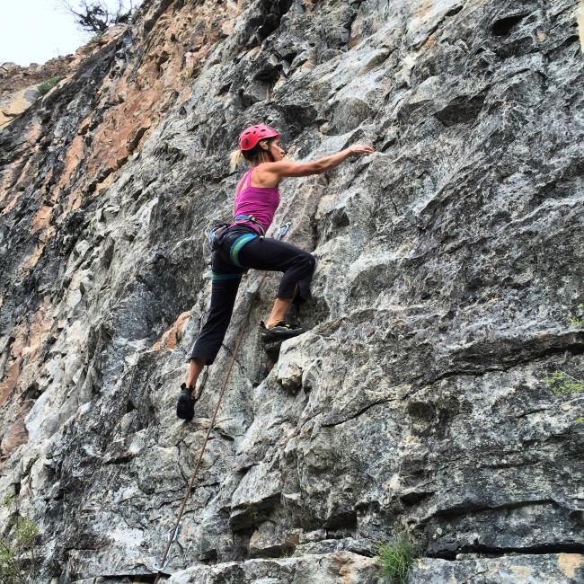Woman climbing rocks Chicks Climbing