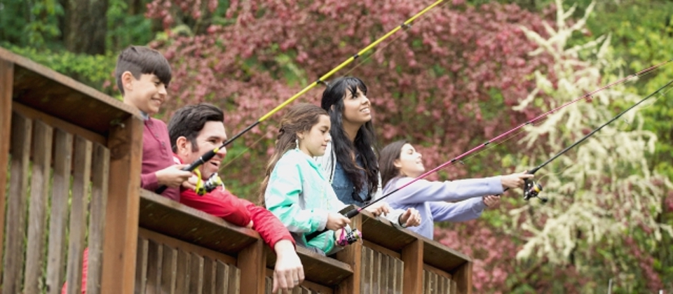 Family fishing on bridge