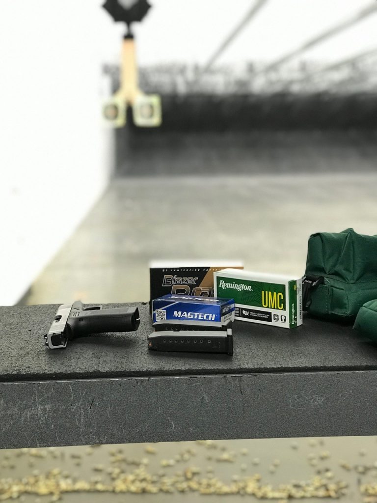 Glock 43X on bench at range with ammo