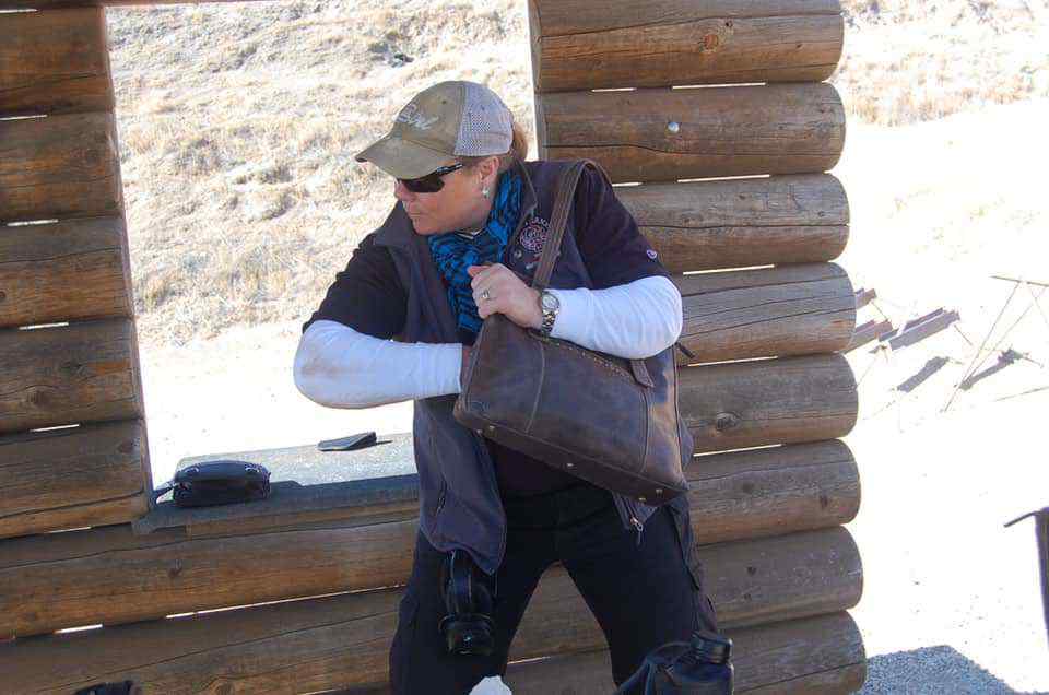 Concealed Carry Instructor Course Trains Women to Carry Off-Body Donna drawing from purse