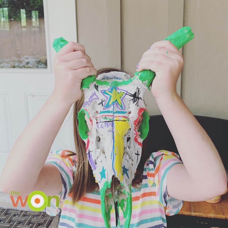 child with deer skull painted