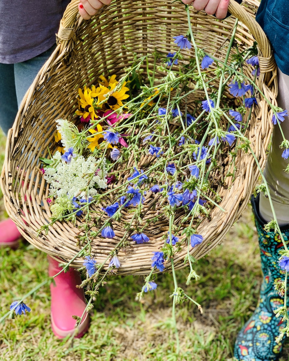 garden boots full basket of wild flowers