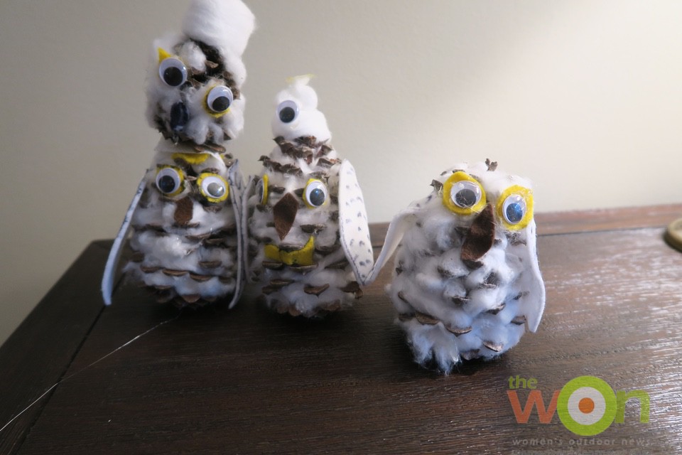 pinecone snowy owls in a line