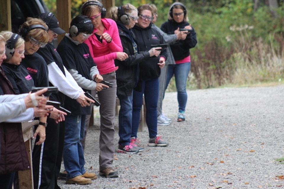 ARMED and Feminine female instructors teaching women