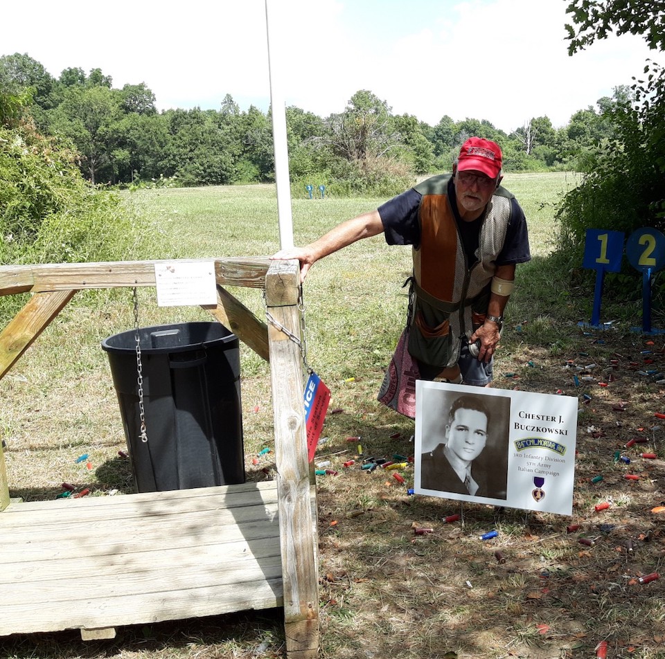 Paul, one of our event participants, pictured with a station sign in memory of his father. Paul is a veteran himself and attends our event every year. (Clays for Heroes photo)