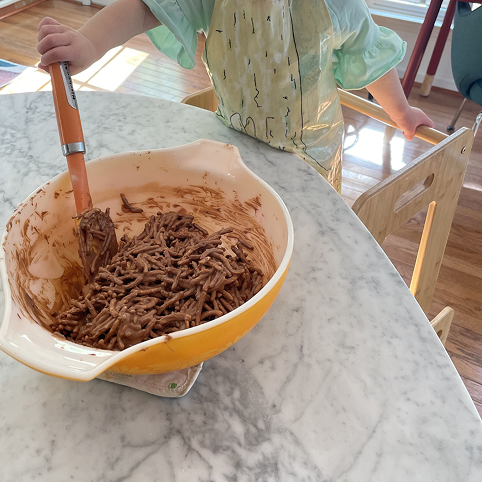 Little Helper Stirring Chow Mein Noodles into Mixture