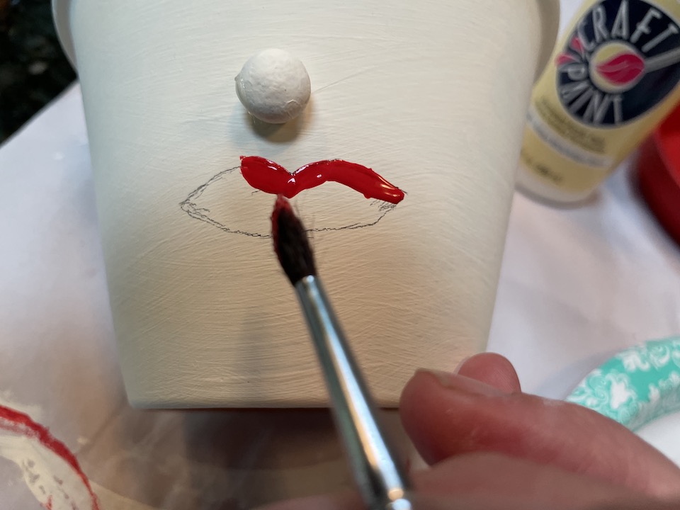 Draw and paint lips on pot
