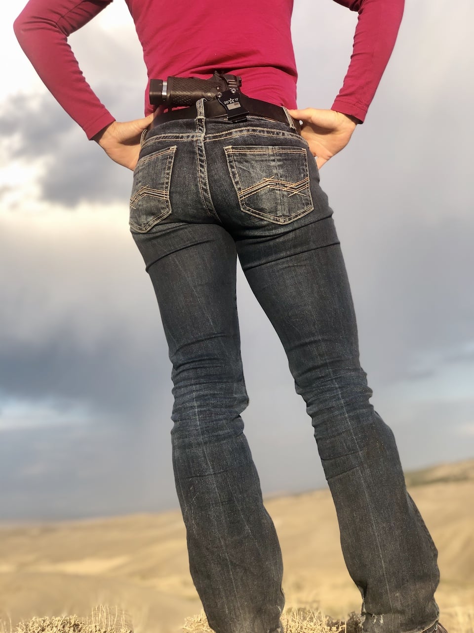 woman carrying handgun in the field