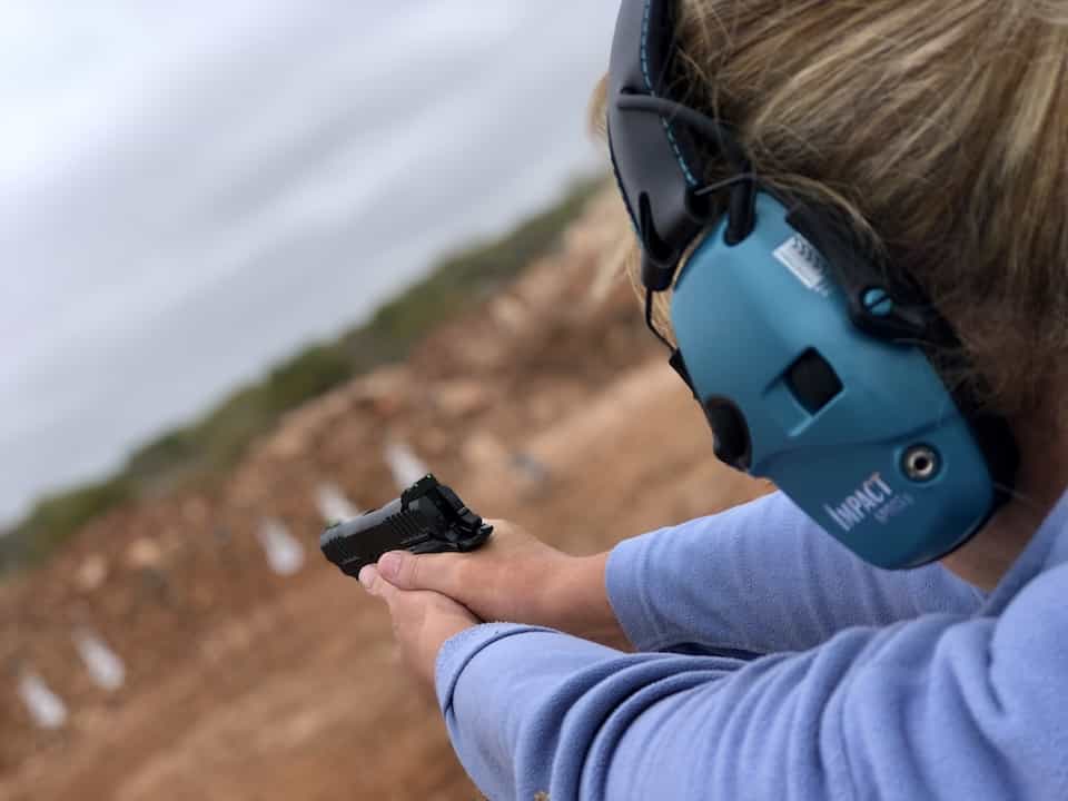 woman practicing for concealed carry