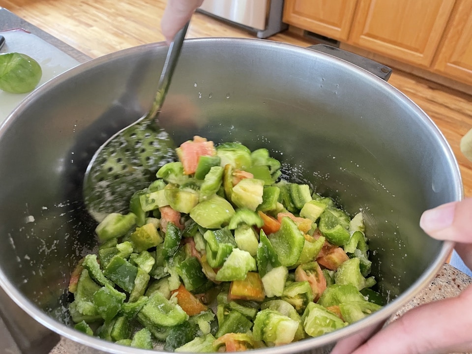 stirring a pot of green tomato relish