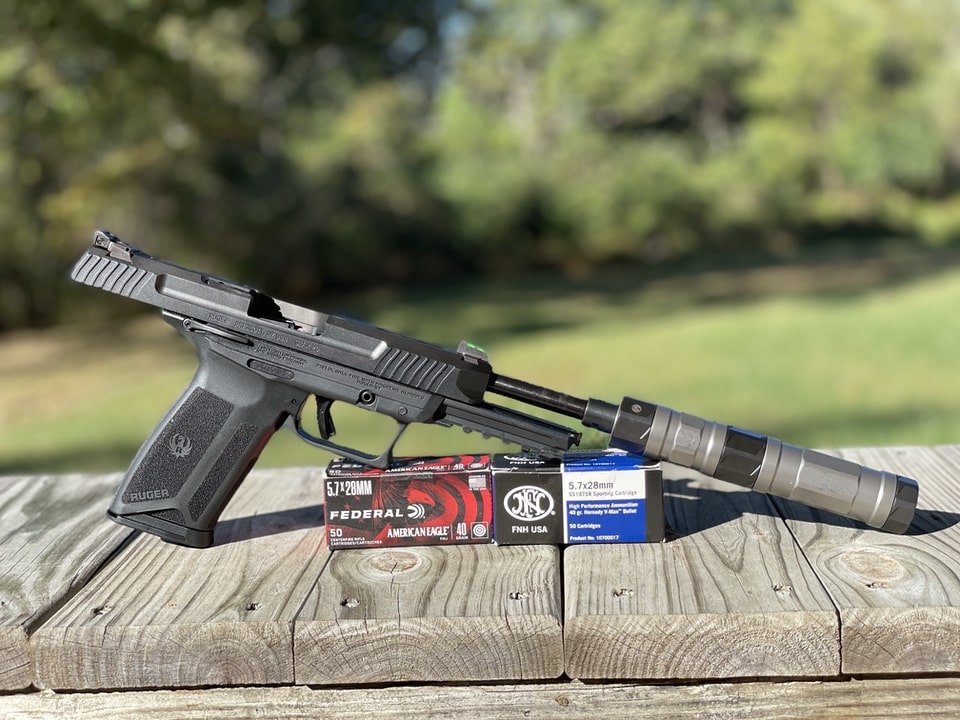 glamour shot of Ruger 57 with threaded barrel and silencer