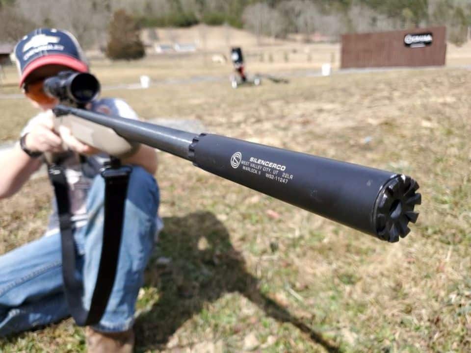 SILENCERCO PLINKING ARTICLE YOUNG SHOOTER JESSE SCOTT ON THE RANGE WITH SAVAGE .22 RIFLE AND WARLOCK SUPPRESSOR 1500 WIDTH