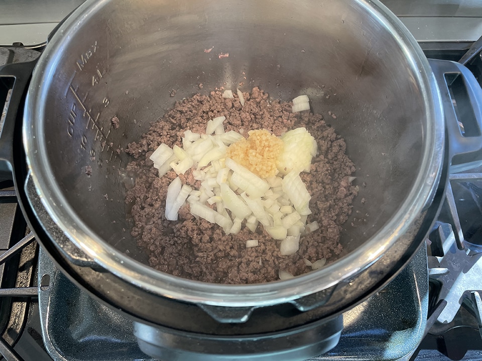 Saute onion and garlic with venison Instant Pot