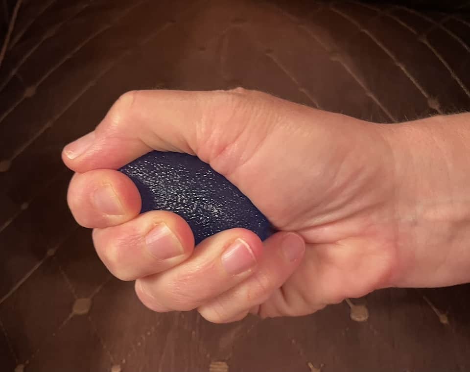 Squeeze the ball with the pads of your fingers and thumb