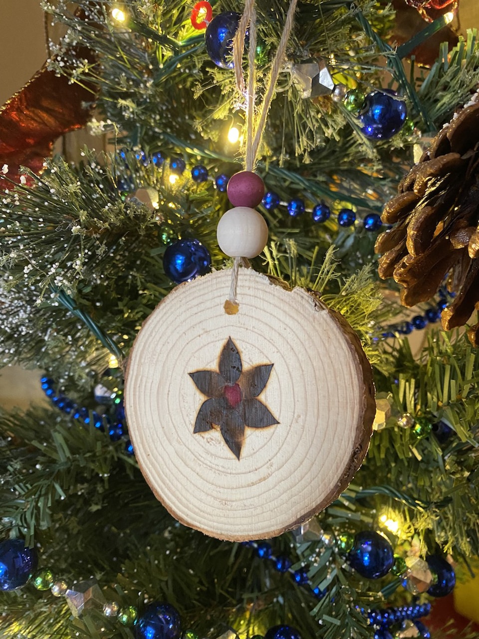 Anna's poinsetta wood christmas ornament with pokeberry stain