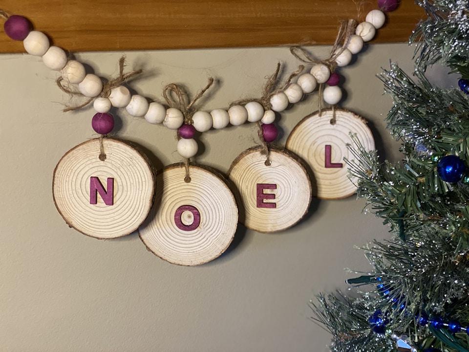 Stain wooden letters and glue them to wood cookies to make a holiday banner