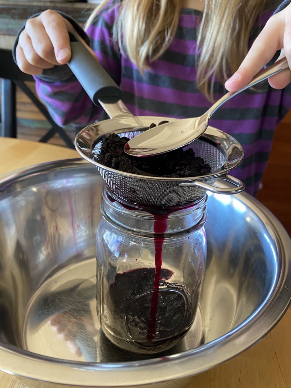 Straining the pokeberries to create a stain