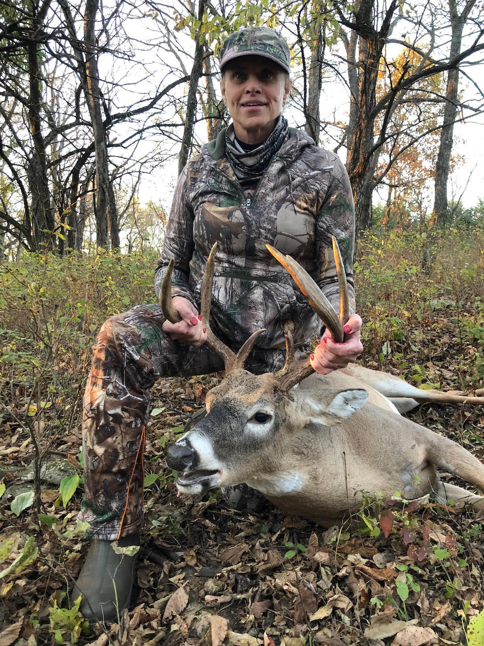 woman with buck in camo