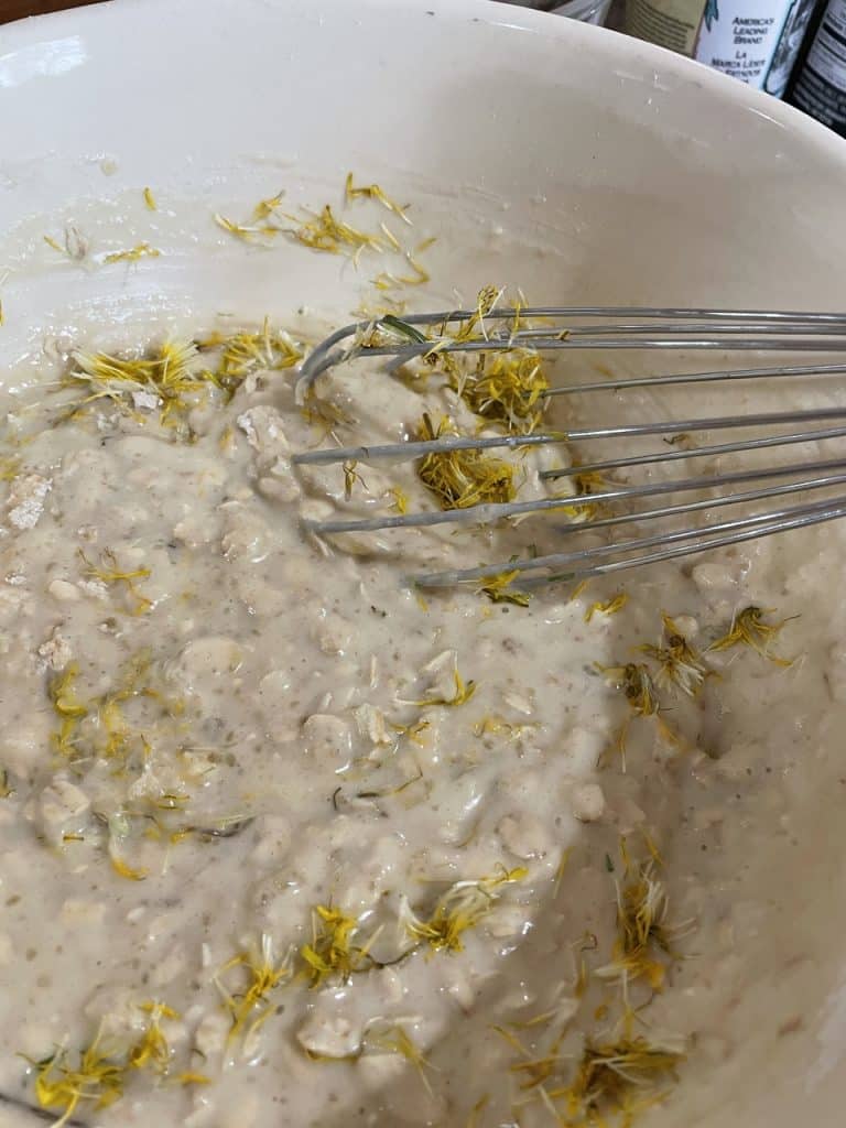mixing dandelions into muffin batter