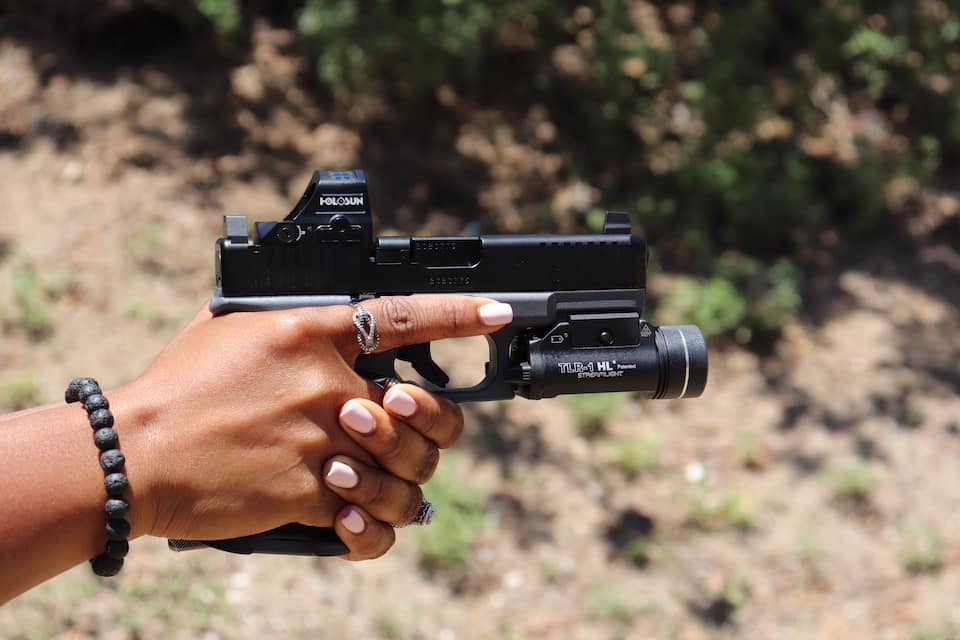 Avery Skipalis finger resting on side of firearm frame