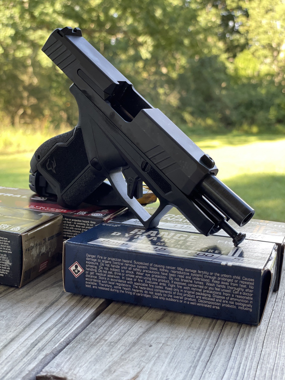 Taurus GX4XL on range with ammo boxes