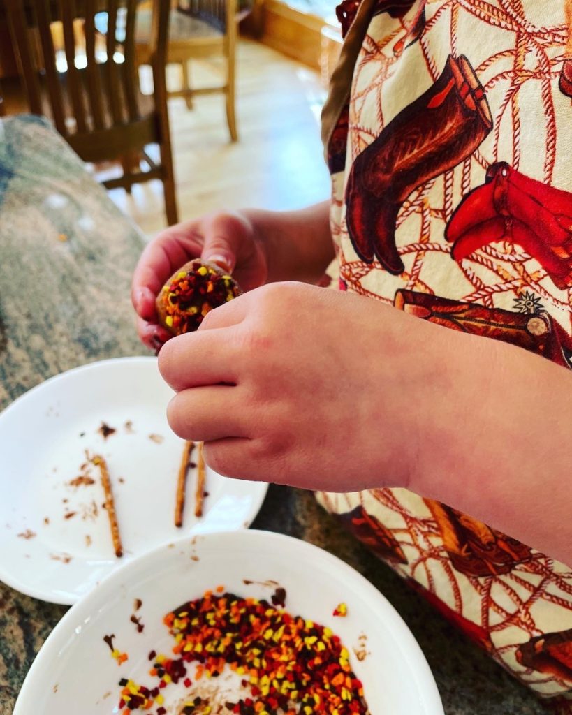 adding toothpicks to donut hole acorns