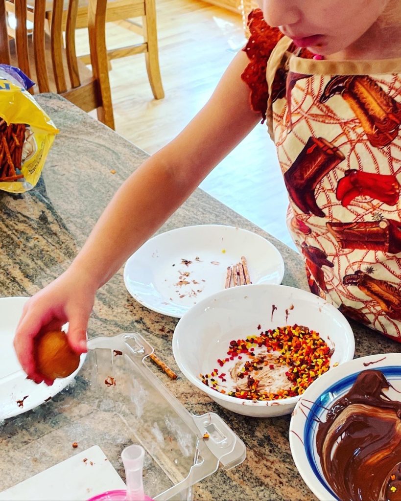 girl making donut hole acorns