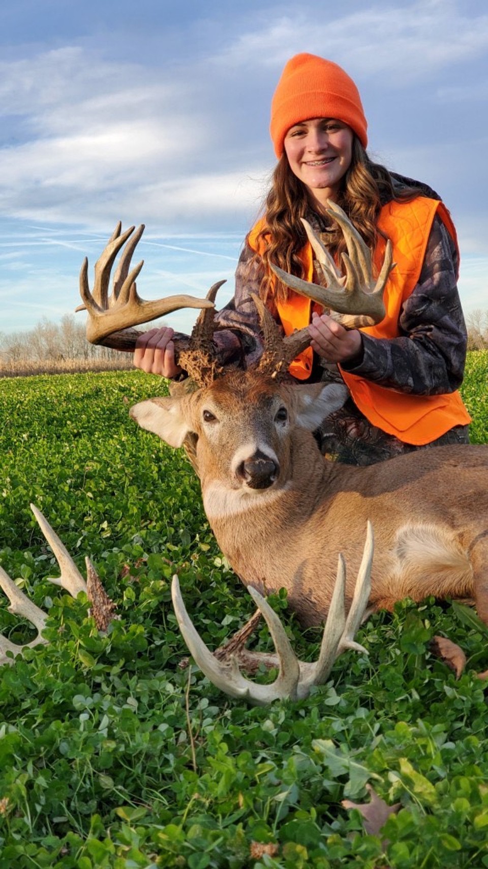 Claire Flood with big buck and sheds (Joe Brown photo)