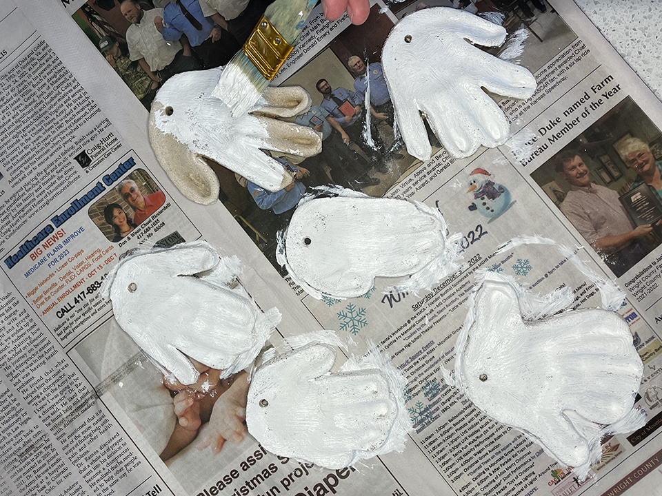 Adding white paint to handprints