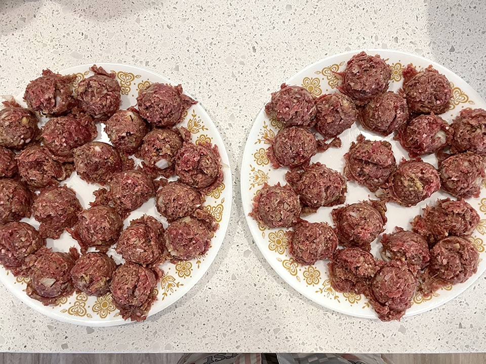 2 plates scooped out Salisbury Steak meatballs