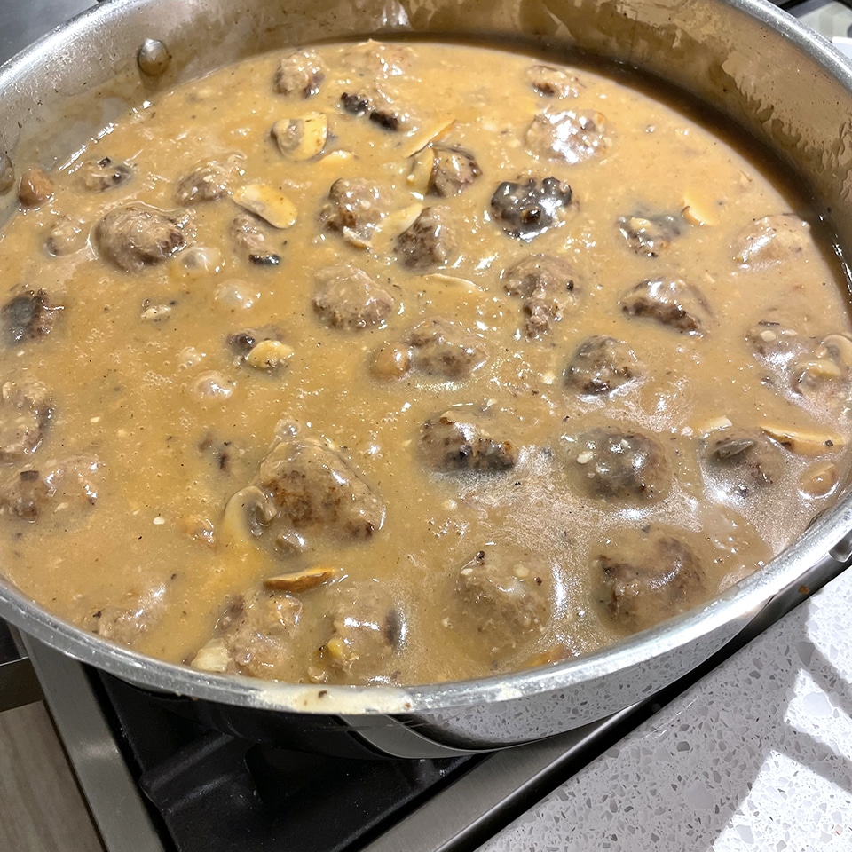 Salisbury Steak meatballs cooking in the gravy