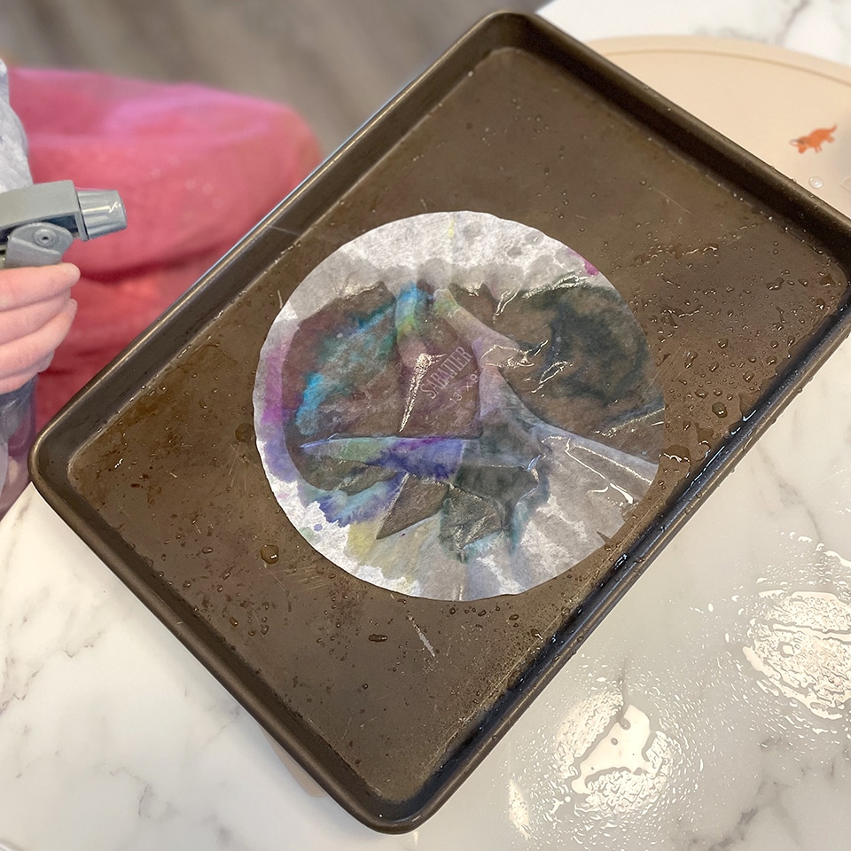 Spraying the coffee filters with water