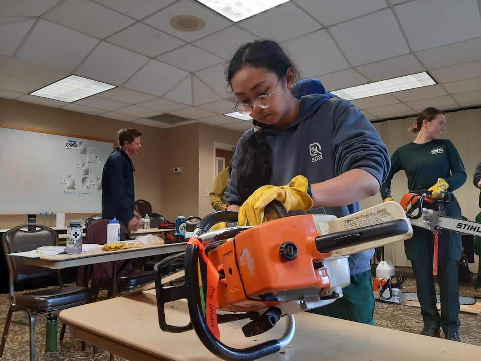 During basic fire training, Student Conservation Association interns became certified as a firefighter Type-2. That designation means they can perform fire suppression and fuels management duties in adverse climate, fuel, and terrain conditions. Dani Fauzi, crewmember with the women's wildland fire crew has experience working with trails and recreation through Conservation Corps positions. (USDA Forest Service photo by Megan Saylors)