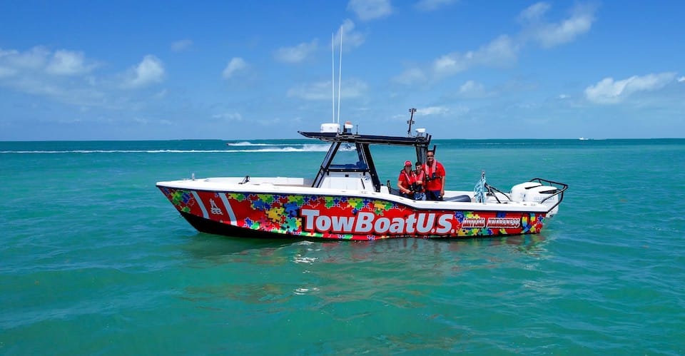 TowBoatUS Islamorada’s (L to R) Ilene Perez, Leif Diaz and Capt. Carlos Galindo aboard their 32-foot, puzzle-piece response vessel. autism awareness