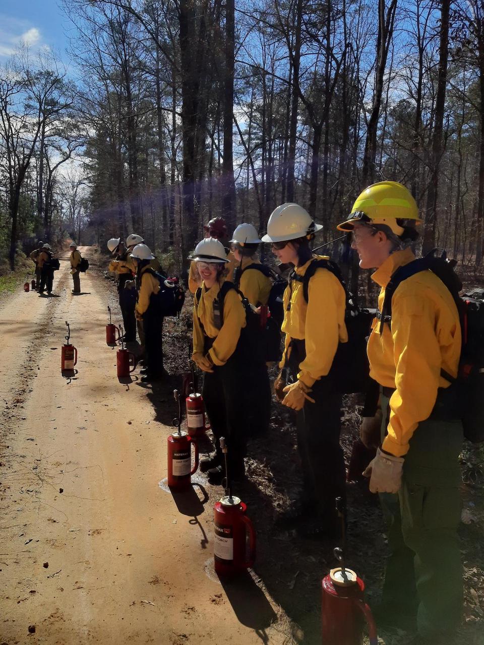 Members of the all-female wildland fire crew were briefed by Megan Saylors, the crew superintendent with the Forest Service, before conducting a prescribed fire. The crew will work and travel throughout the Southern Region, gaining hands-on experience in fire and fuels management work. (USDA Forest Service photo by Megan Saylors)