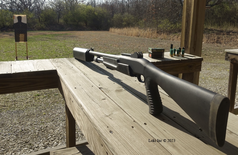 shotgun and suppressor on bench