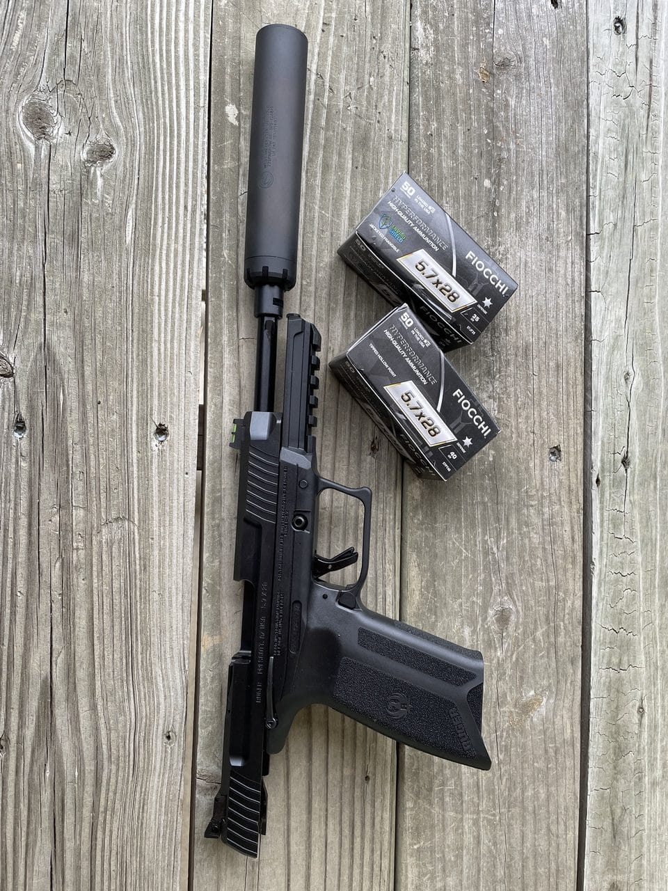 Ruger-57 on bench with ammo and silencer