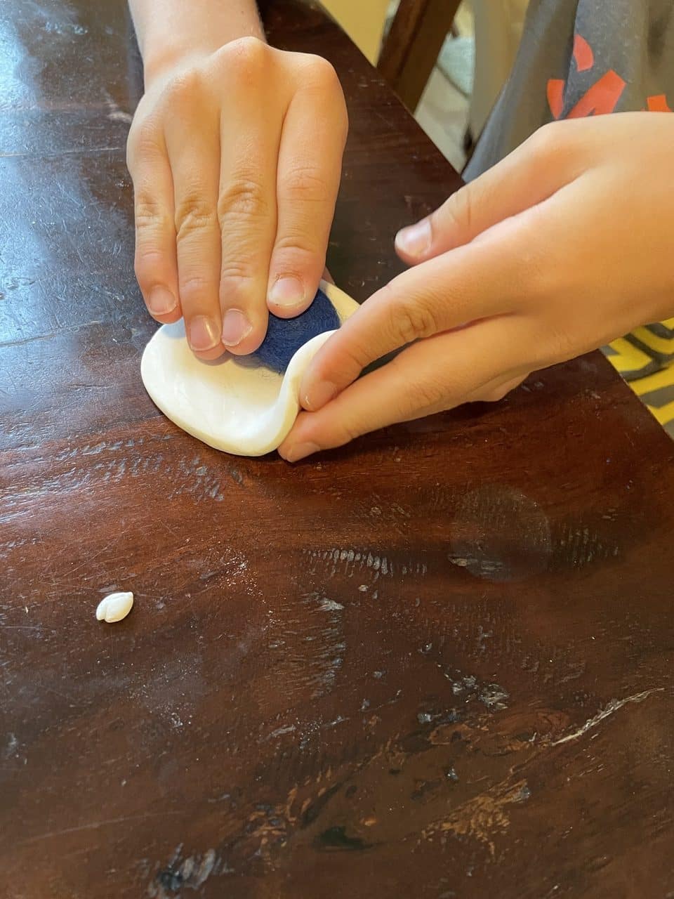 shaping clay around wool ball