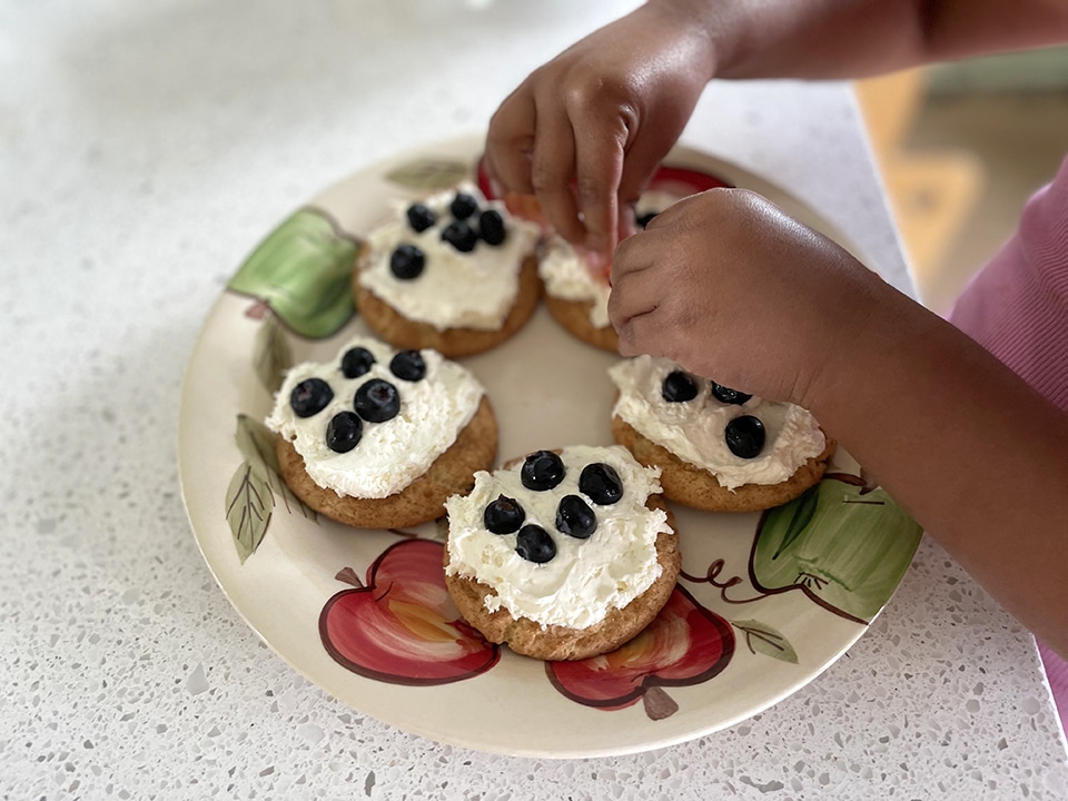 Decorating the mini fruit pizzas 2