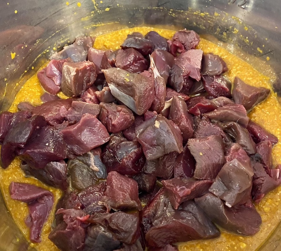 Adding the duck meat the pureed sauce