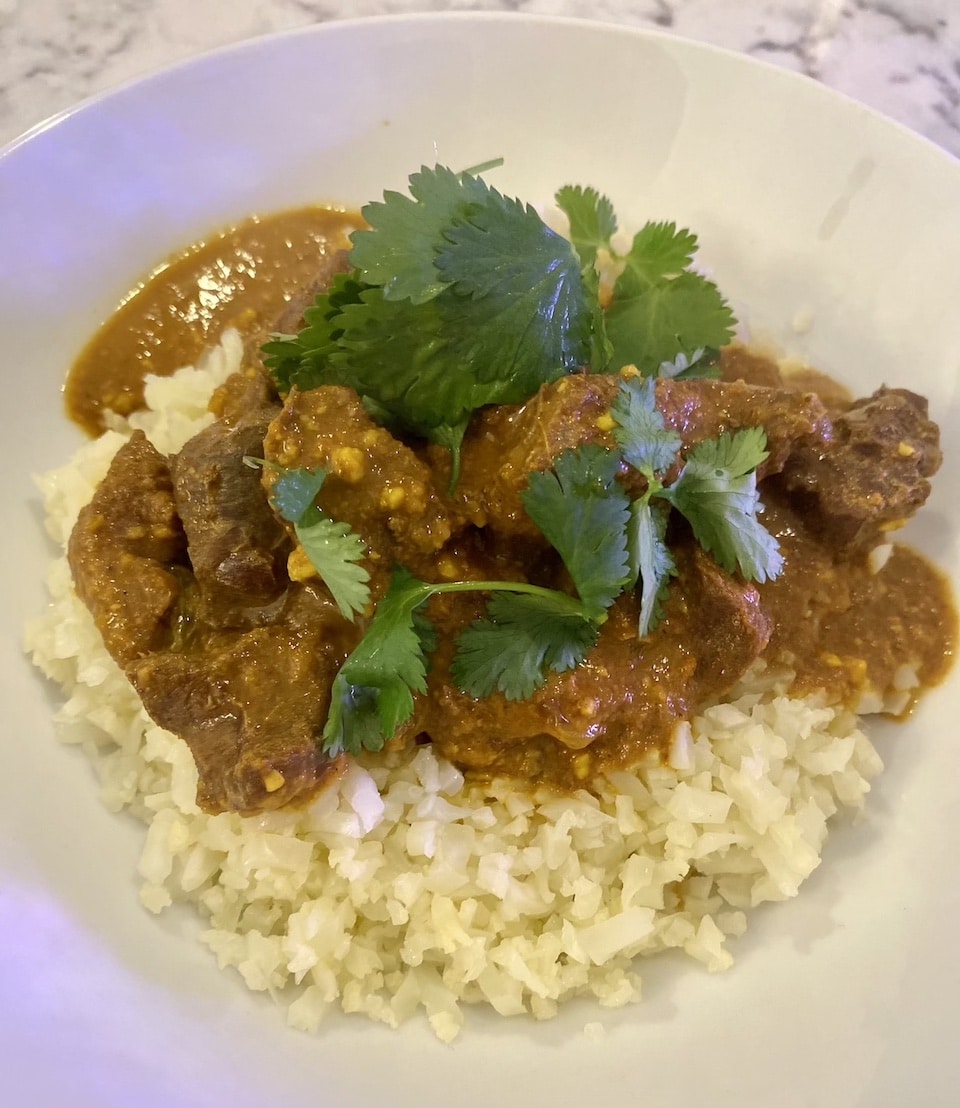 Wild duck korma with cilantro on cauliflower rice