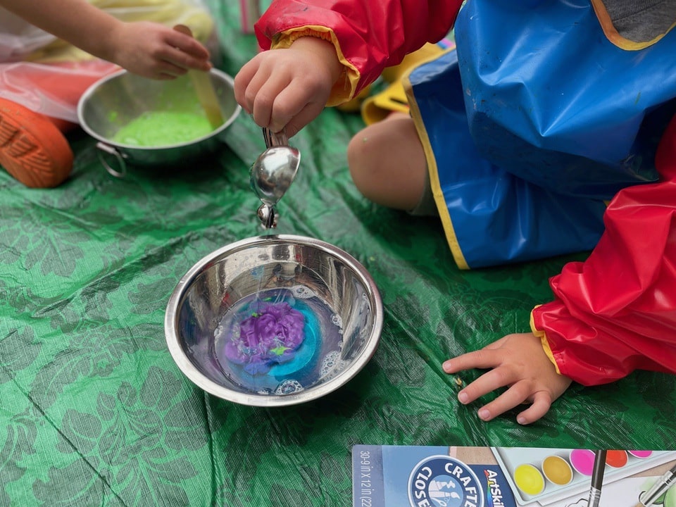 boy mixing paints and dish soap