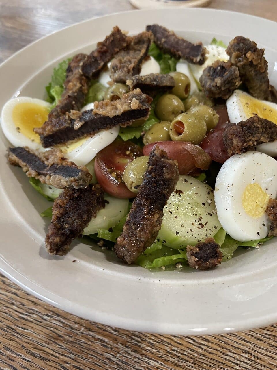 fried backstrap on a salad