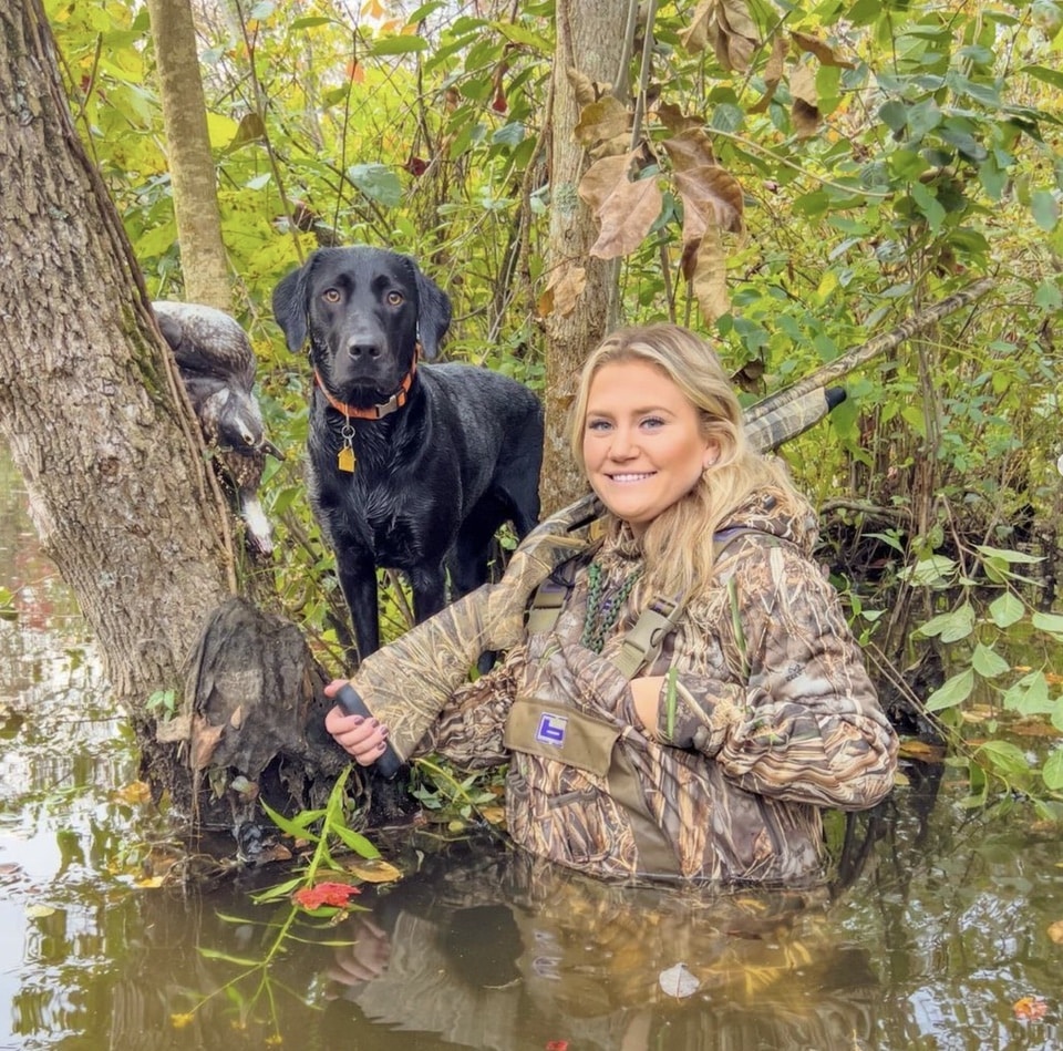 Megan Watts with dog and Syren shotgun waterfowl hunting