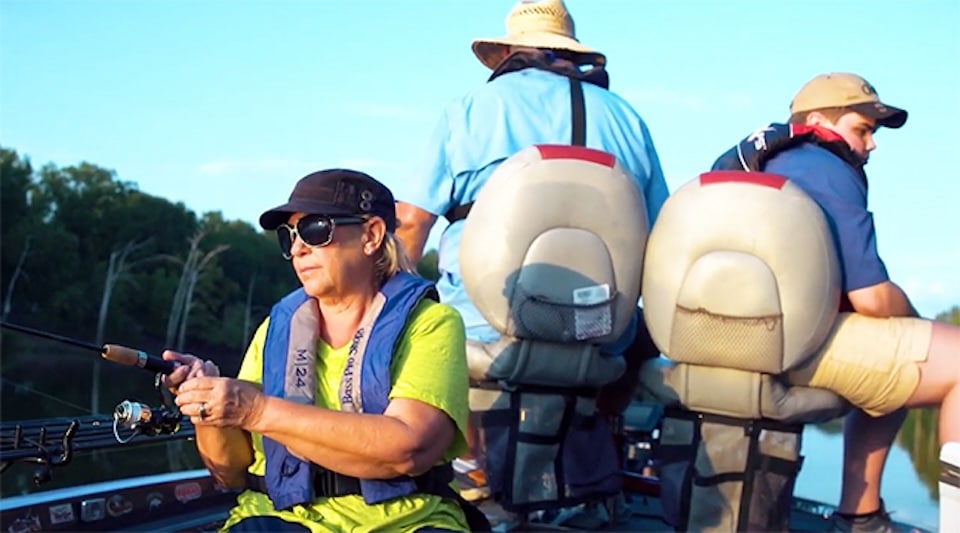 Lady fishing on boat Fishing for Your Planet