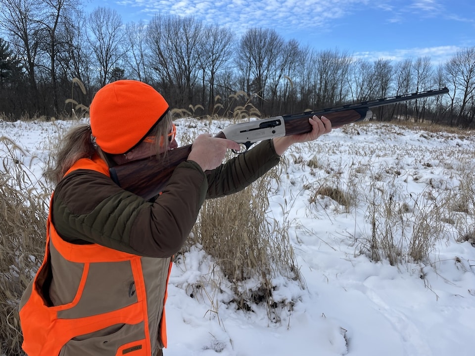 Michelle shooting Beretta A400 upland in field