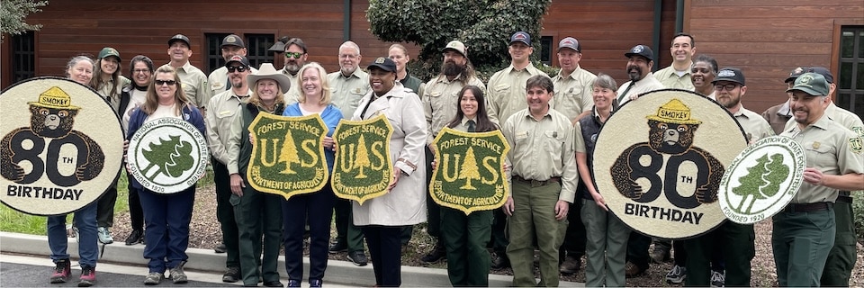 The decorating team for the 2024 Rose Parade shows off their handiwork in front the Angeles National Forest Supervisor's Office. (USDA Forest Service photo)