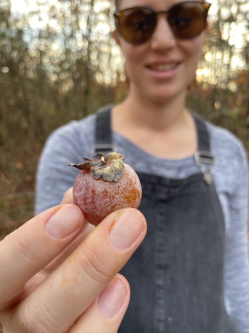 woman holding persimmon